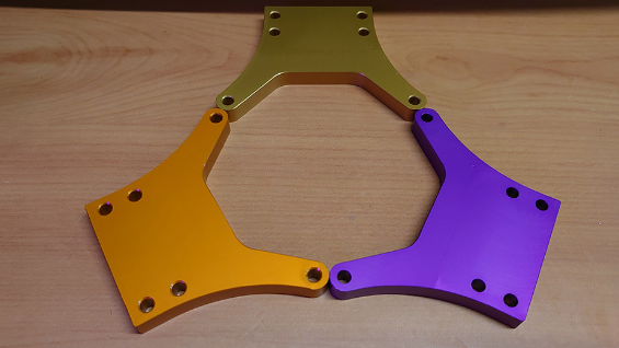 An image of the Front Shock Towers for the Nitrotek Aowei Yama Buggy, in the three colours we sell them in: orange, purple and gold.