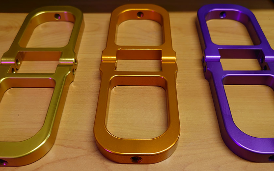 This picture features each of the three colours of Front Upper Suspension Arms for the Nitrotek Aowei Yama Buggy, in orange, purple and gold.